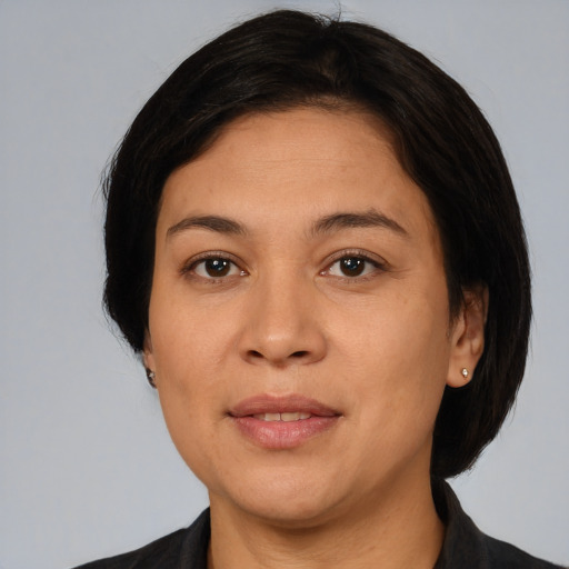 Joyful white adult female with medium  black hair and brown eyes