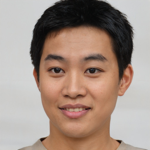 Joyful asian young-adult male with short  black hair and brown eyes