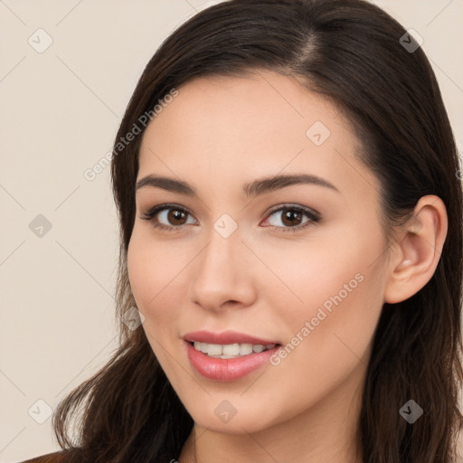 Joyful white young-adult female with long  brown hair and brown eyes