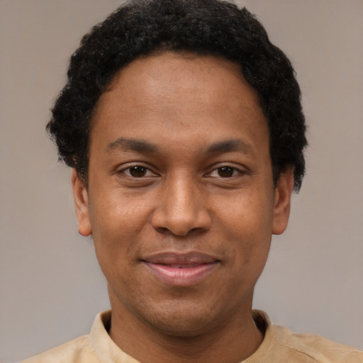 Joyful latino young-adult male with short  brown hair and brown eyes