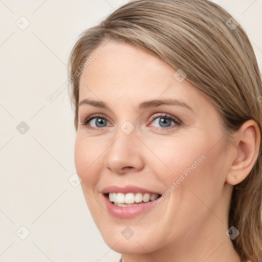 Joyful white young-adult female with long  brown hair and blue eyes