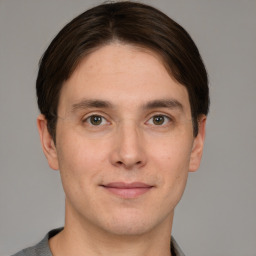 Joyful white young-adult male with short  brown hair and grey eyes