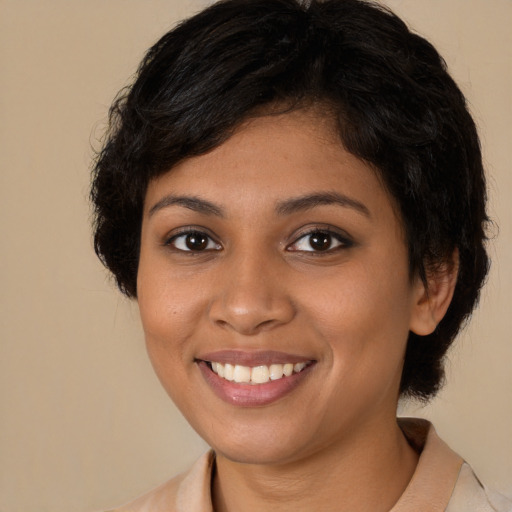 Joyful black young-adult female with medium  brown hair and brown eyes