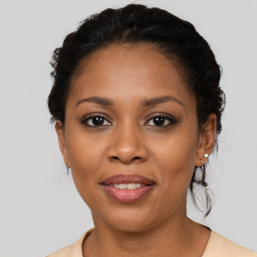 Joyful black young-adult female with short  brown hair and brown eyes