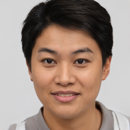 Joyful asian young-adult female with short  brown hair and brown eyes