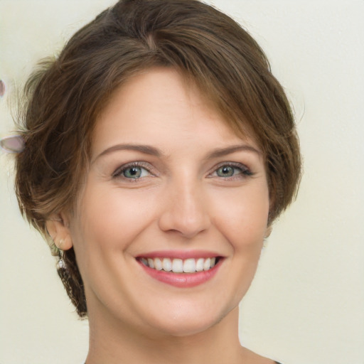 Joyful white young-adult female with medium  brown hair and green eyes