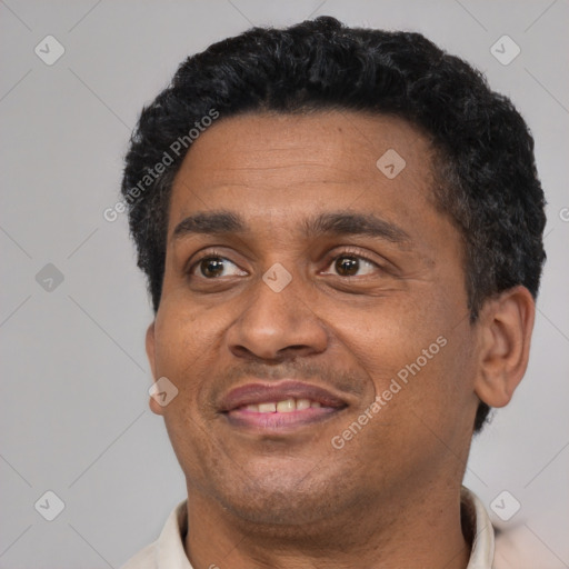 Joyful black adult male with short  black hair and brown eyes