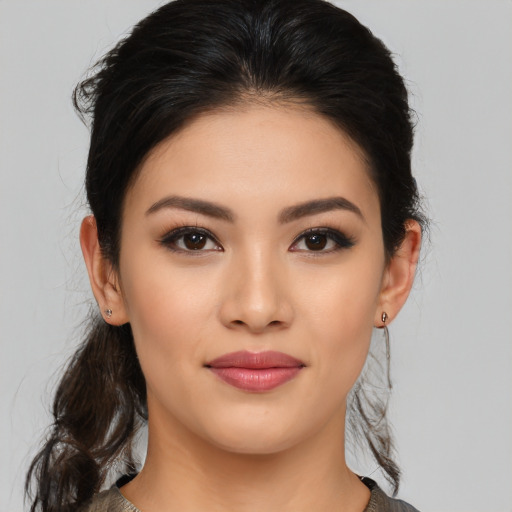 Joyful asian young-adult female with medium  brown hair and brown eyes