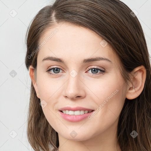 Joyful white young-adult female with long  brown hair and grey eyes