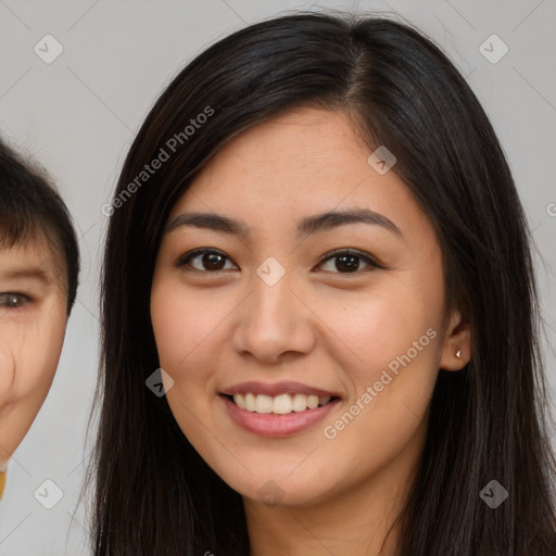 Joyful asian young-adult female with long  brown hair and brown eyes