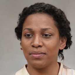 Joyful black adult female with short  brown hair and brown eyes