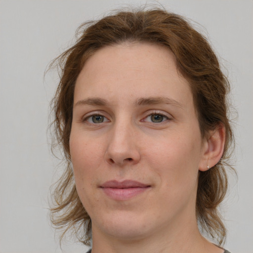 Joyful white young-adult female with medium  brown hair and green eyes