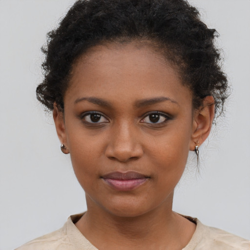Joyful black young-adult female with short  brown hair and brown eyes