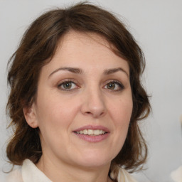 Joyful white young-adult female with medium  brown hair and blue eyes