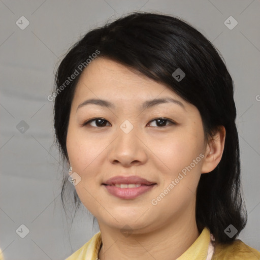 Joyful asian young-adult female with medium  black hair and brown eyes