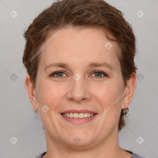 Joyful white adult female with short  brown hair and grey eyes