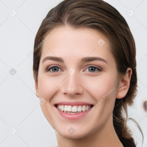 Joyful white young-adult female with long  brown hair and grey eyes