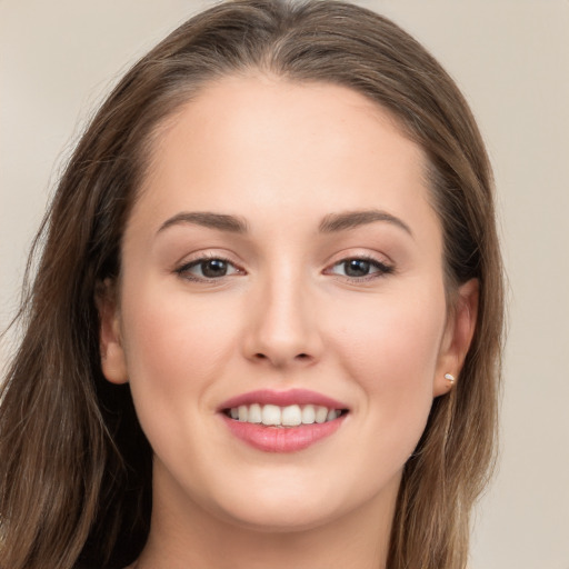 Joyful white young-adult female with long  brown hair and grey eyes