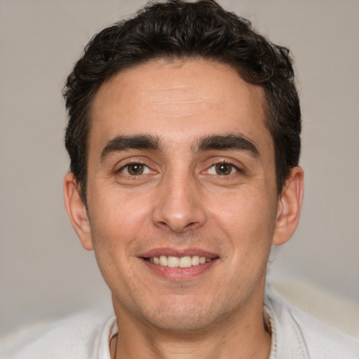 Joyful white adult male with short  brown hair and brown eyes