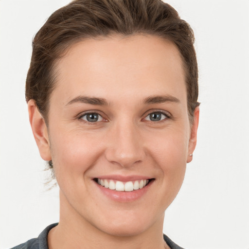 Joyful white young-adult female with short  brown hair and grey eyes