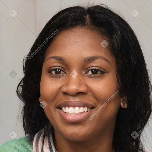 Joyful black young-adult female with long  black hair and brown eyes