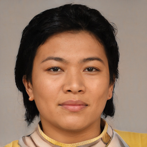 Joyful asian young-adult female with short  black hair and brown eyes