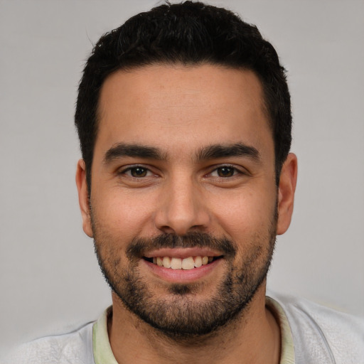 Joyful white young-adult male with short  black hair and brown eyes