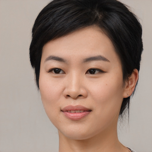 Joyful asian young-adult female with medium  black hair and brown eyes