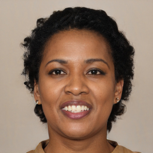 Joyful black young-adult female with medium  black hair and brown eyes
