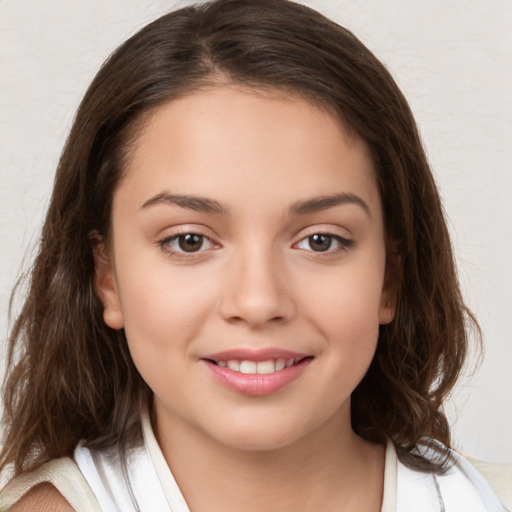 Joyful white child female with medium  brown hair and brown eyes