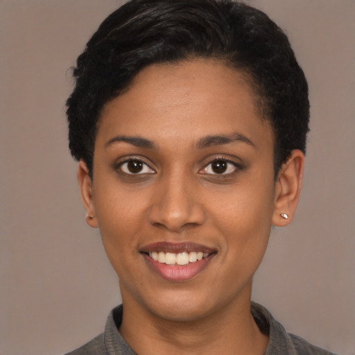 Joyful latino young-adult female with short  black hair and brown eyes