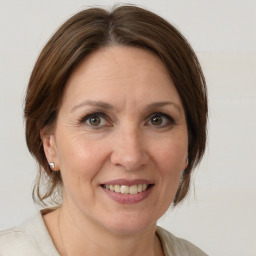 Joyful white adult female with medium  brown hair and grey eyes