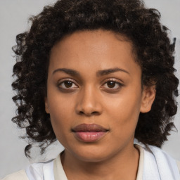 Joyful black young-adult female with medium  brown hair and brown eyes