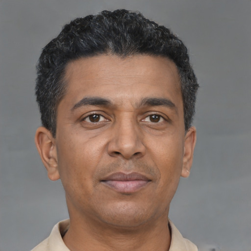 Joyful latino adult male with short  brown hair and brown eyes