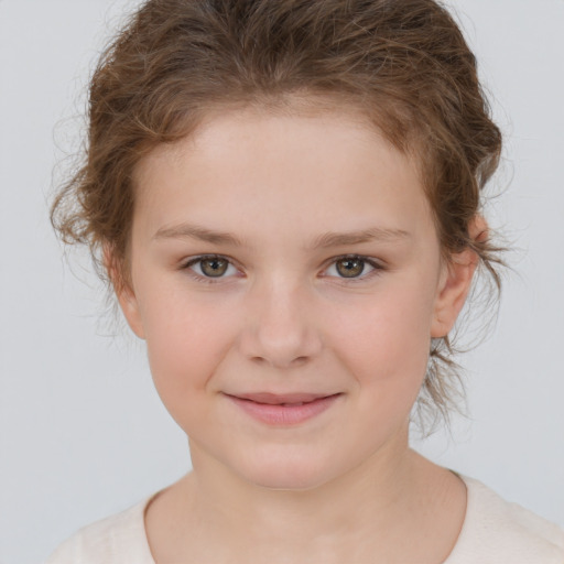 Joyful white child female with short  brown hair and brown eyes