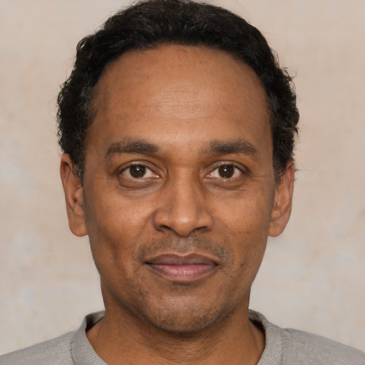 Joyful latino adult male with short  black hair and brown eyes