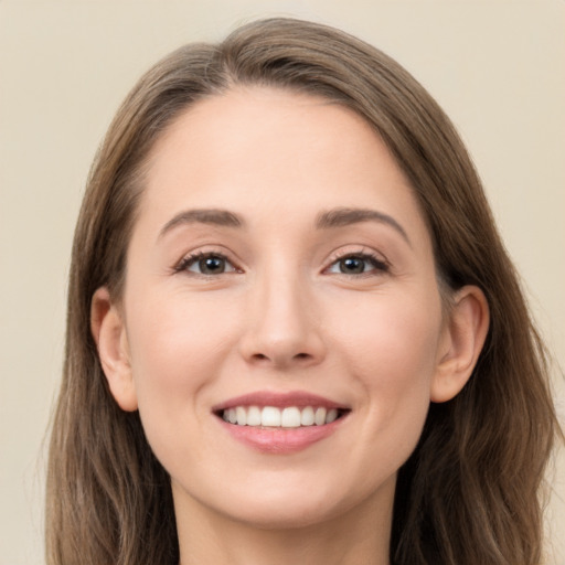 Joyful white young-adult female with long  brown hair and grey eyes