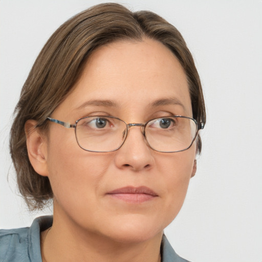 Joyful white adult female with medium  brown hair and blue eyes