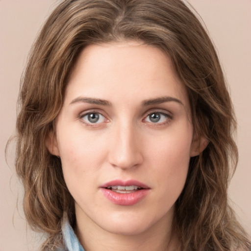 Joyful white young-adult female with long  brown hair and green eyes