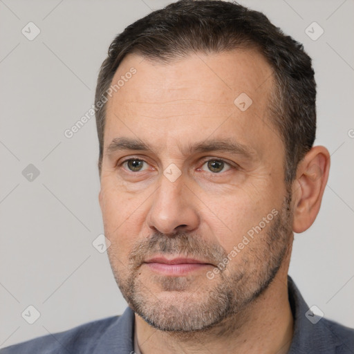 Joyful white adult male with short  black hair and brown eyes