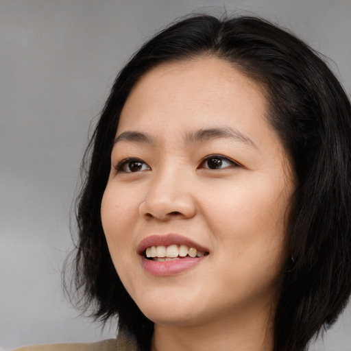 Joyful asian young-adult female with long  black hair and brown eyes