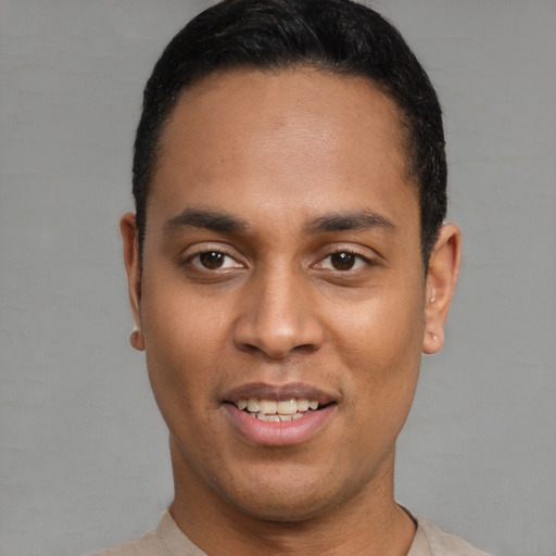 Joyful latino young-adult male with short  black hair and brown eyes