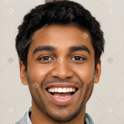 Joyful latino young-adult male with short  black hair and brown eyes