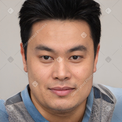 Joyful asian young-adult male with short  brown hair and brown eyes