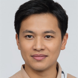 Joyful asian young-adult male with short  black hair and brown eyes