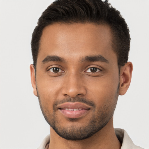 Joyful black young-adult male with short  brown hair and brown eyes