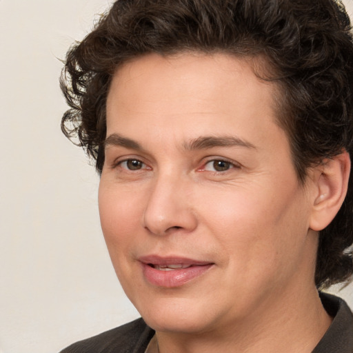 Joyful white adult male with medium  brown hair and brown eyes