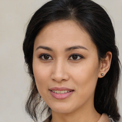 Joyful asian young-adult female with medium  brown hair and brown eyes