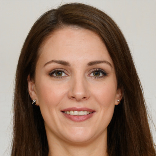 Joyful white young-adult female with long  brown hair and grey eyes