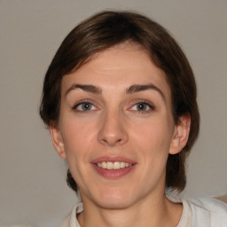 Joyful white young-adult female with medium  brown hair and grey eyes